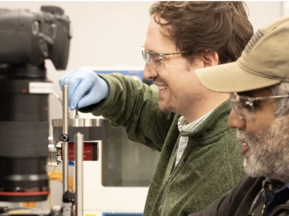 Reddy and Battle prepare to take spectra of meteorites that will help them better understand asteroid surfaces. These measurements are taken in the lab at the Kuiper Space Science Building.