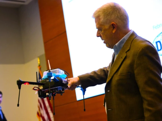 Darren Cofer, principal fellow at Collins Aerospace demonstrates the company’s Secure Mathematically-Assured Composition of Control Models (SMACCM) capabilities at a DARPA demonstration day. (Photo courtesy of DARPA.)