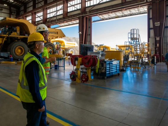 Komatsu experts Mark Schaeffer, vice president for strategy (left), and Neil Johnson, test development manager (right) in the Komatsu Arizona Proving Grounds workshop near Tucson, Arizona.