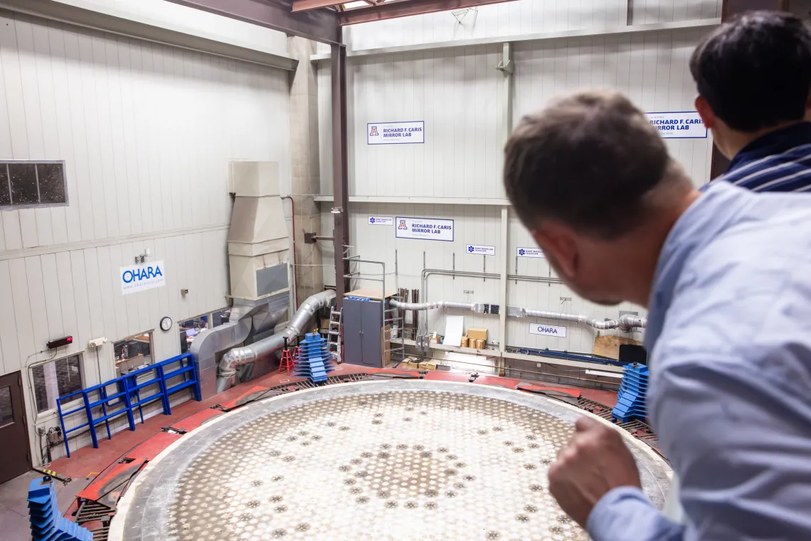 back of head of person and mirror casting station at mirror casting station.