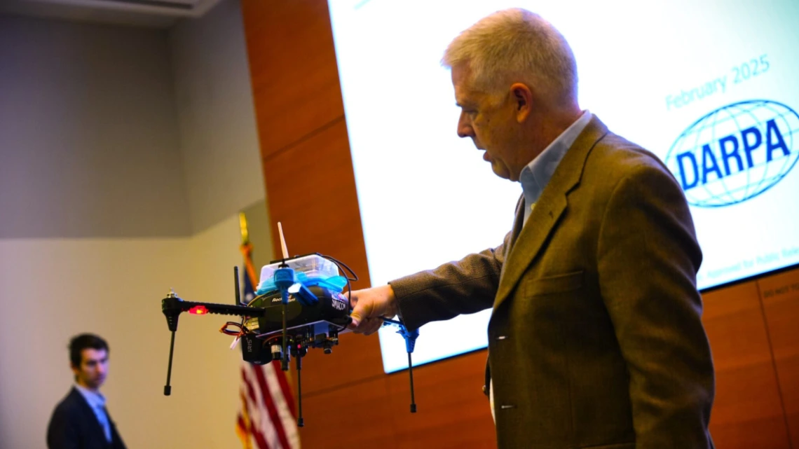 Darren Cofer, principal fellow at Collins Aerospace demonstrates the company’s Secure Mathematically-Assured Composition of Control Models (SMACCM) capabilities at a DARPA demonstration day. (Photo courtesy of DARPA.)