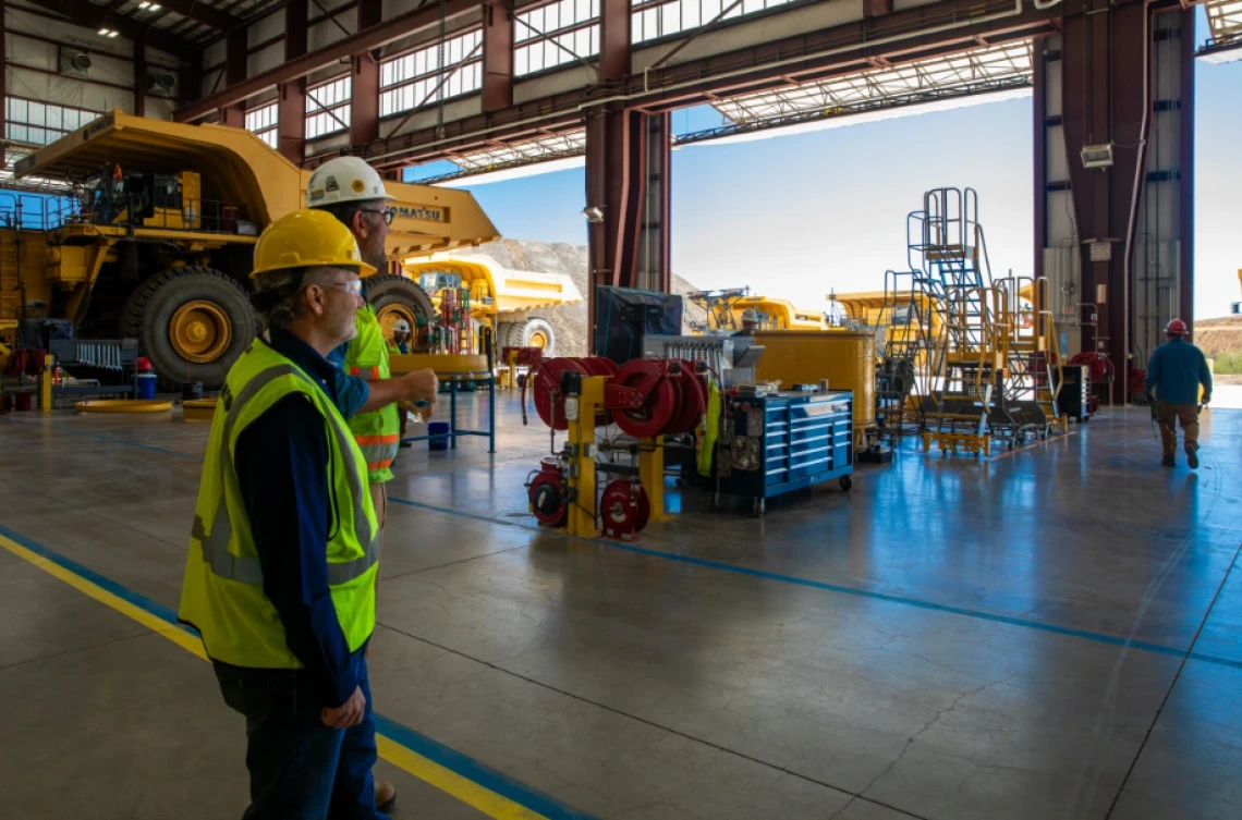 Komatsu experts Mark Schaeffer, vice president for strategy (left), and Neil Johnson, test development manager (right) in the Komatsu Arizona Proving Grounds workshop near Tucson, Arizona.