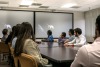 Professor and students of aerospace and mechanical engineering discuss space image on classroom screen. 